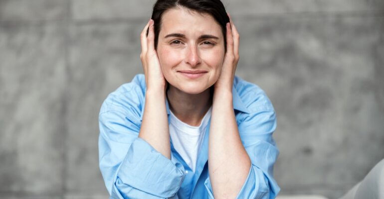 young,stressed,woman,wearing,casual,shirt,,sitting,on,couch,and