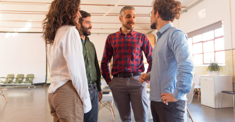 Professionals in corporate environment communicating in English