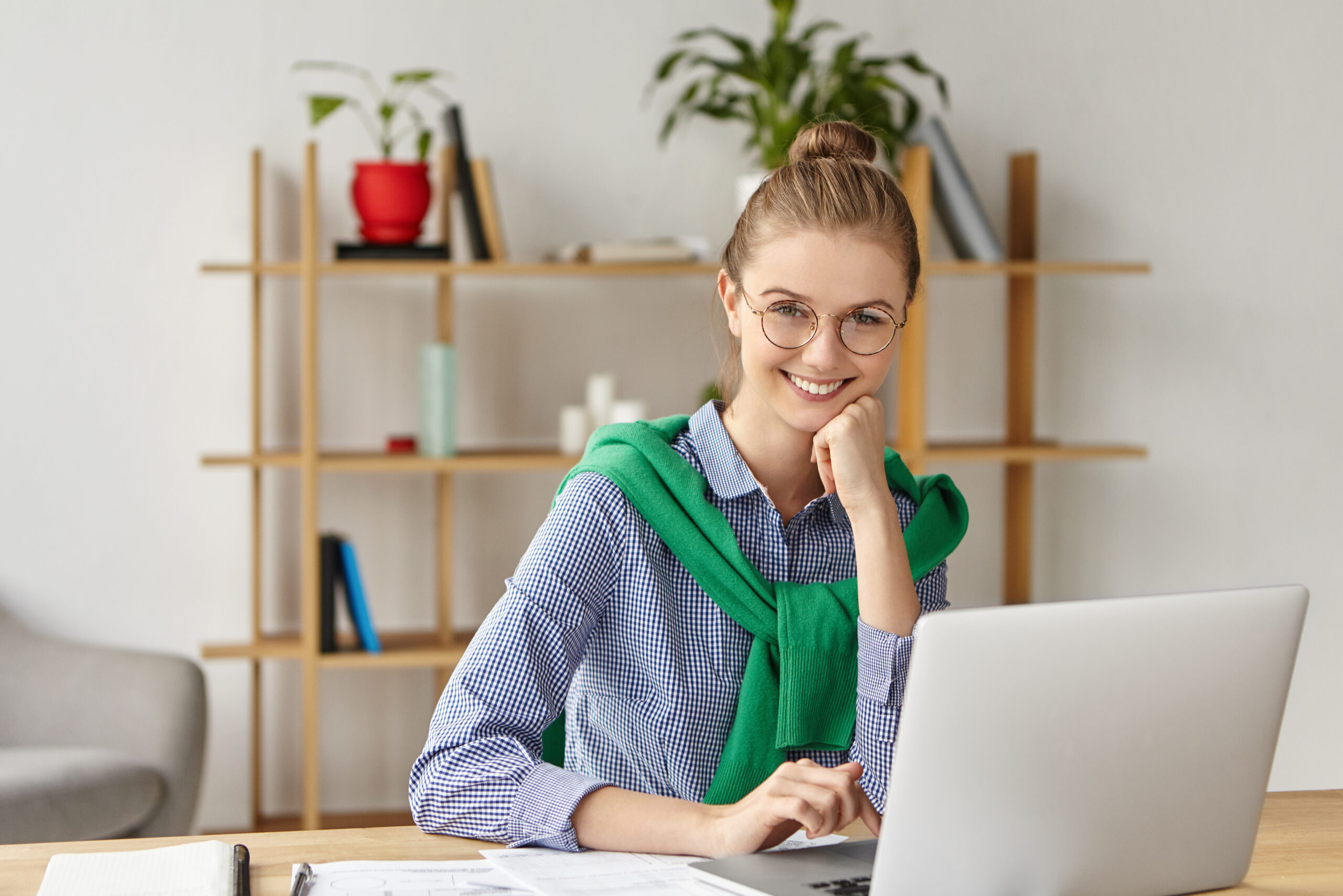 People, lifestyle and technology concept. Happy young cute female office worker works on report, studies papers, glad to be praised by boss, finds out about promotion, has proffesional growth